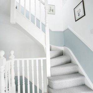Grey carpeted stairs with white and blur wallpaper leading to a new loft conversion in Bristol